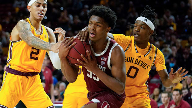 Stanford’s Harrison Ingram (55) gets double-teamed by Arizona State’s Jalen Graham (2) and DJ Horne (0) during the second half of an NCAA college basketball game, Saturday, March 5, 2022, in Tempe, Ariz.